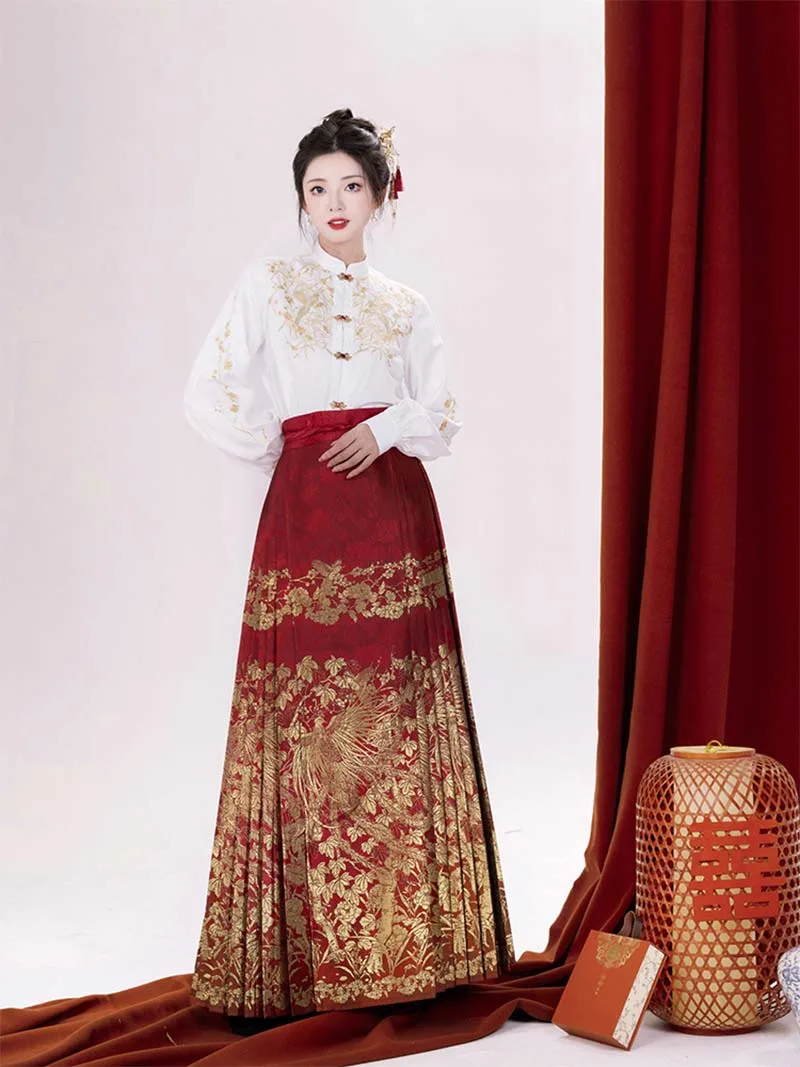Red woven brocade mamian skirt with Ming-style cloud-shoulder hanfu, traditional Chinese festive dress for wedding toasts and New Year celebrations.