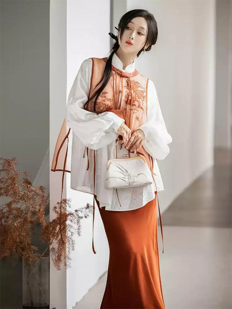Modernised hanfu with embroidered vest, mandarin collar shirt, and fishtail skirt in orange autumn style