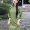 Elegant green qipao dress with full front opening and floor-length vintage Chinese design