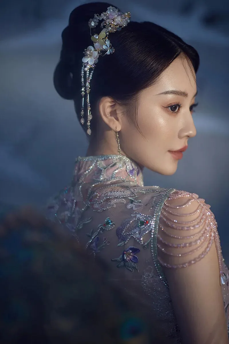 Qipao elegance captured in soft light, revealing the timeless grace of Chinese femininity.