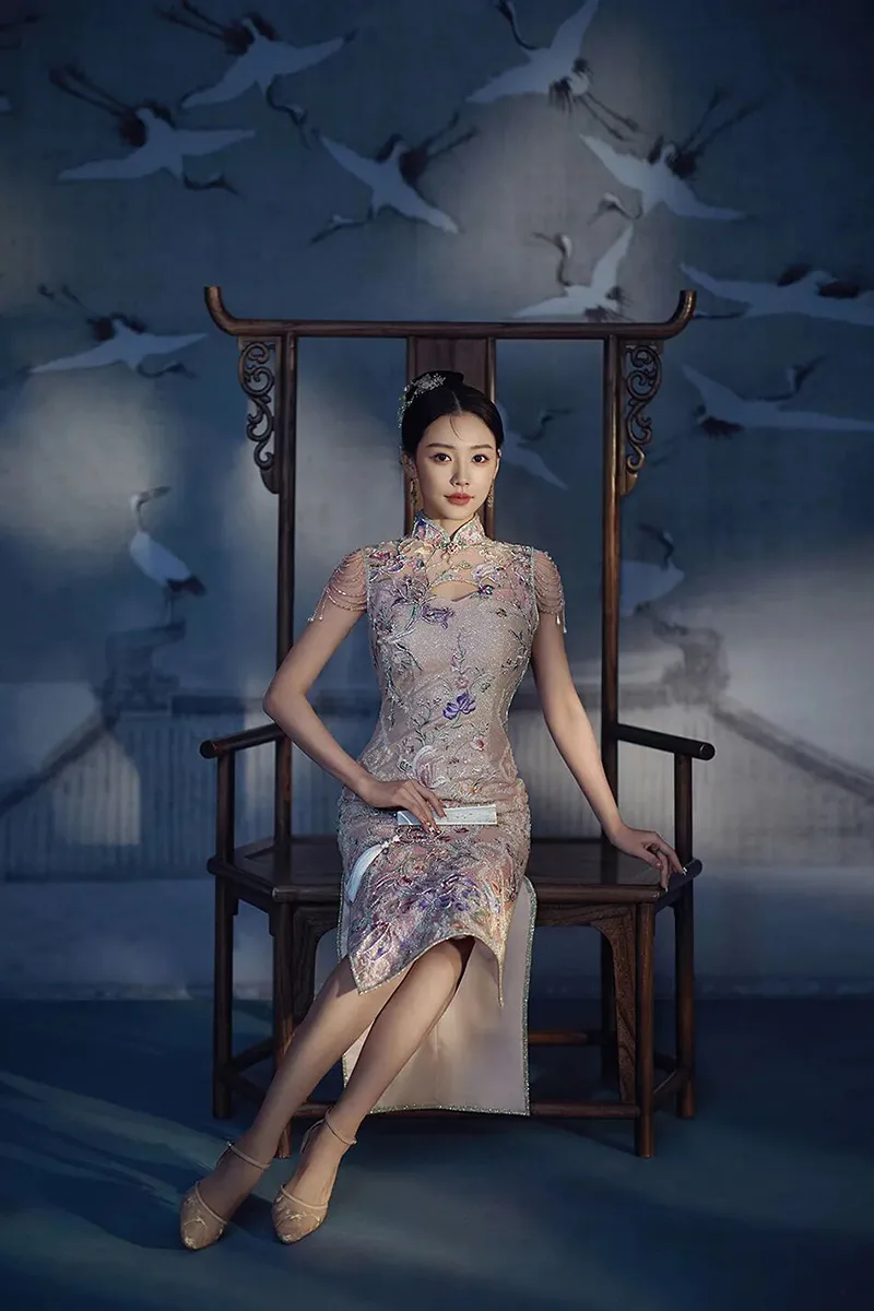 Qipao elegance captured in soft light, revealing the timeless grace of Chinese femininity.