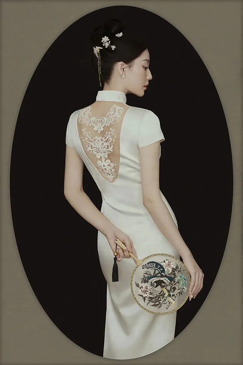 Qipao elegance captured in soft light, revealing the timeless grace of Chinese femininity.