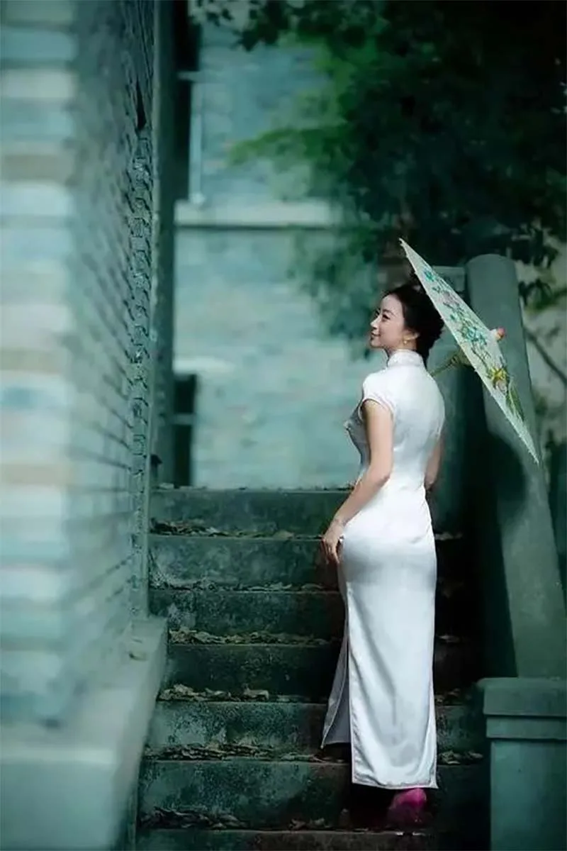 Elegant woman wearing a traditional qipao dress, illustrating cultural taboos to avoid