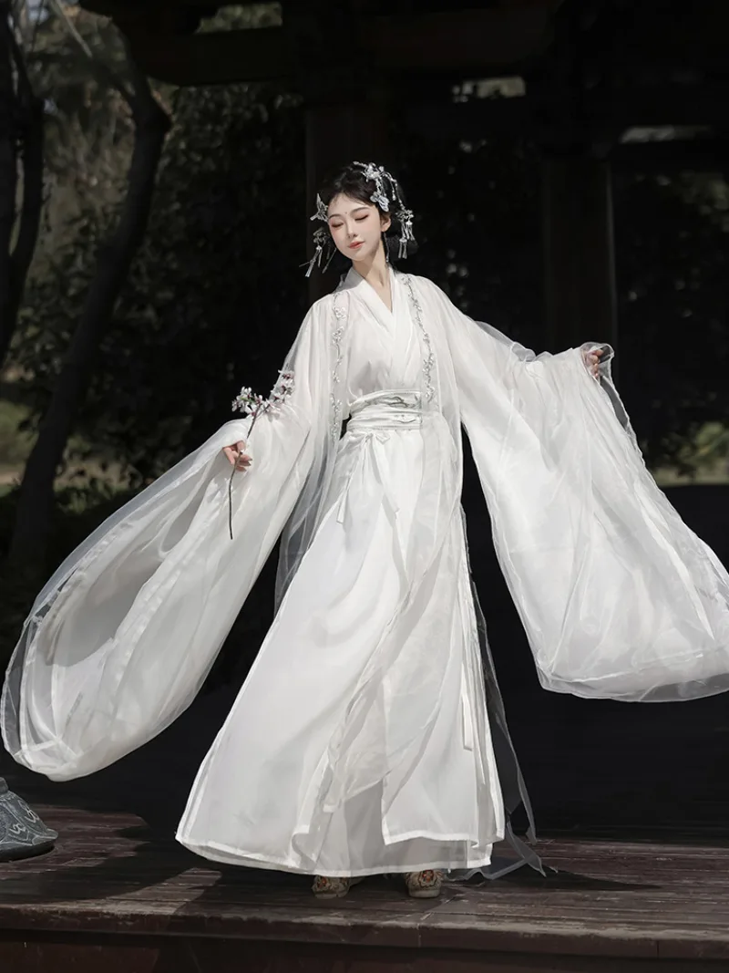 White hanfu outfit for women with wide sleeves and cross-collar design in ethereal traditional Chinese style
