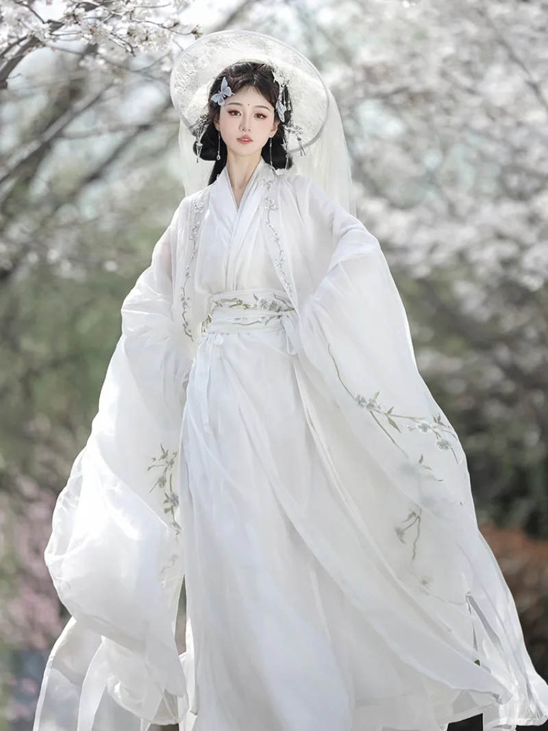 White hanfu outfit for women with wide sleeves and cross-collar design in ethereal traditional Chinese style