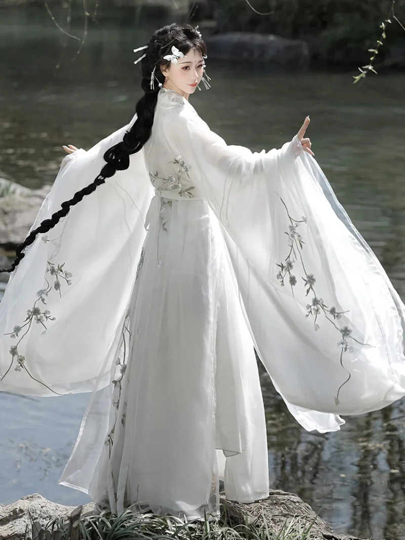 White hanfu outfit for women with wide sleeves and cross-collar design in ethereal traditional Chinese style