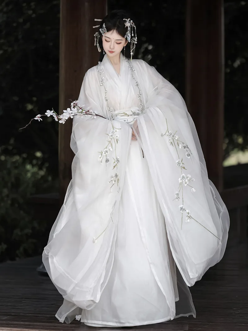 White hanfu outfit for women with wide sleeves and cross-collar design in ethereal traditional Chinese style