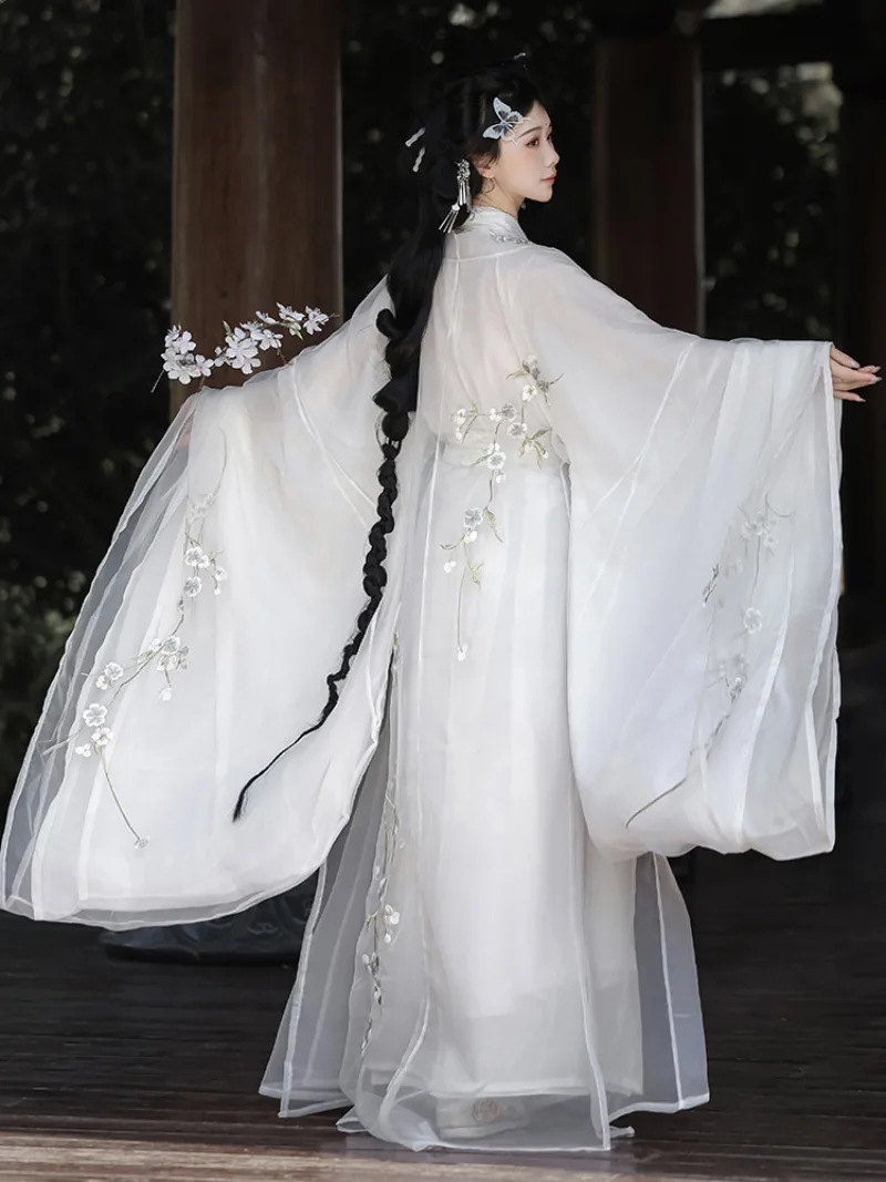 White hanfu outfit for women with wide sleeves and cross-collar design in ethereal traditional Chinese style