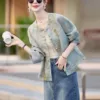 Elegant modern Tang jacket for women with embroidery, jacquard fabric, and traditional frog button details